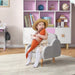 Toddler on grey cloud-design kids armchair with orange plush toy in a modern nursery.