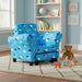 Blue kids armchair with cloud pattern in playroom, teddy bear and wooden blocks on rug