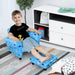 Smiling boy sitting on blue kids armchair with footrest in a modern playroom