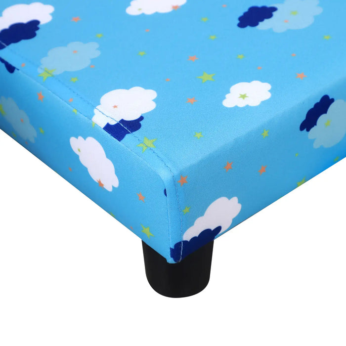 Blue kids' bed corner with cloud and star pattern, black plastic leg visible