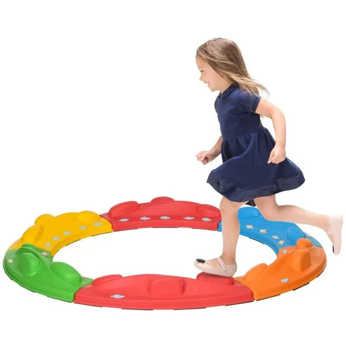 Child balancing on colorful modular balance beam stepping path set in a circle