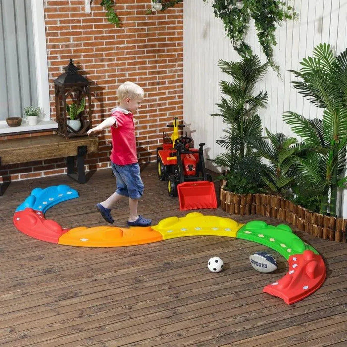 Child playing on colorful 6-piece modular kids balance beam set in outdoor patio area