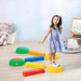 Girl balancing on colorful kids balance beams and stepping stones indoor play set