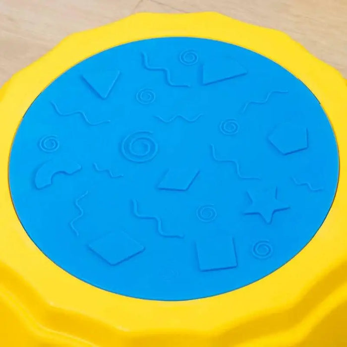 Close-up of a kids' balance beam stepping stone with a blue textured non-slip surface