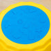 Close-up of a kids' balance beam stepping stone with a blue textured non-slip surface