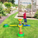Child balancing on colorful kids' balance beams and stepping stones set in backyard