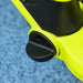 Close-up of green and black kids balance bike footrest on blue textured floor
