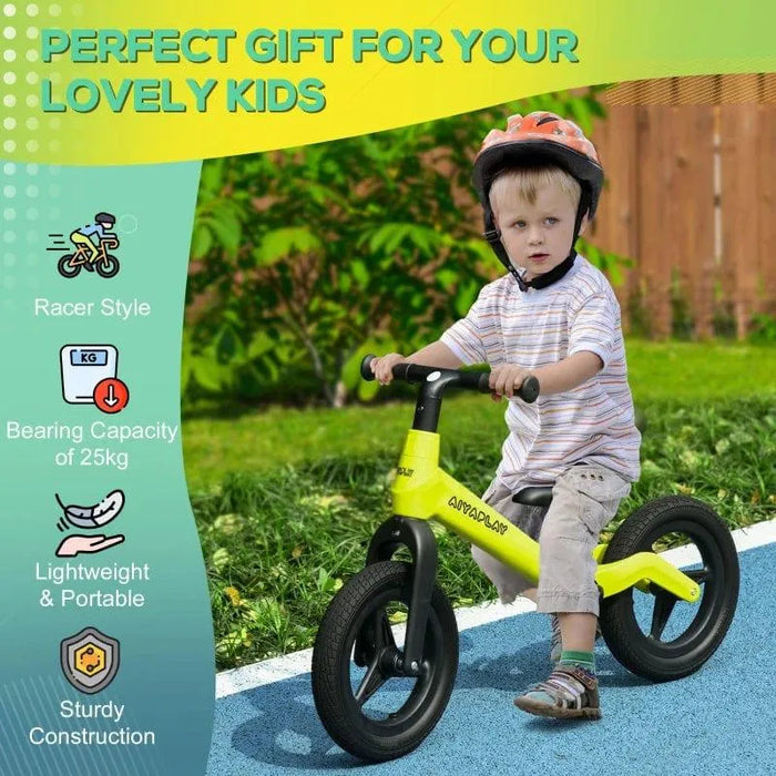 Young boy riding green and black balance bike with helmet outdoors, kids bike features shown.