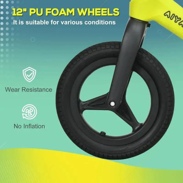 Close-up of green and black kids balance bike 12-inch PU foam wheel, no-inflation, wear resistant.