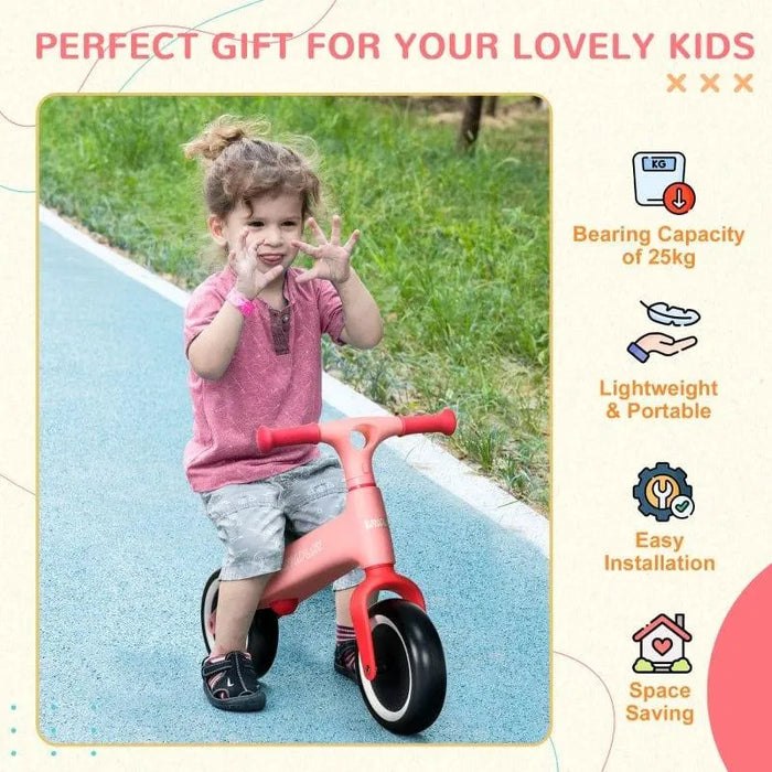 Toddler riding pink balance bike with EVA tyres on outdoor path, lightweight kids bike.