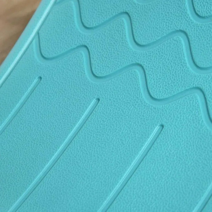Close-up of blue Montessori kids balance board with textured, wavy surface pattern.