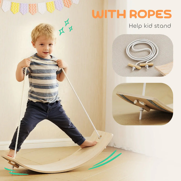 Child using a wooden balance board with ropes for support, indoors.