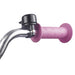 Close-up of pink star-patterned bicycle handlebar grip with attached black bike bell on chrome handlebars
