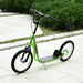 Green kids big wheel scooter with adjustable height and dual brakes on paved path