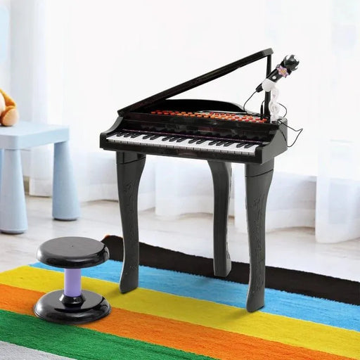 Kids black 37-key mini grand piano set with microphone and stool on colorful rug