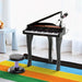 Kids black 37-key mini grand piano set with microphone and stool on colorful rug