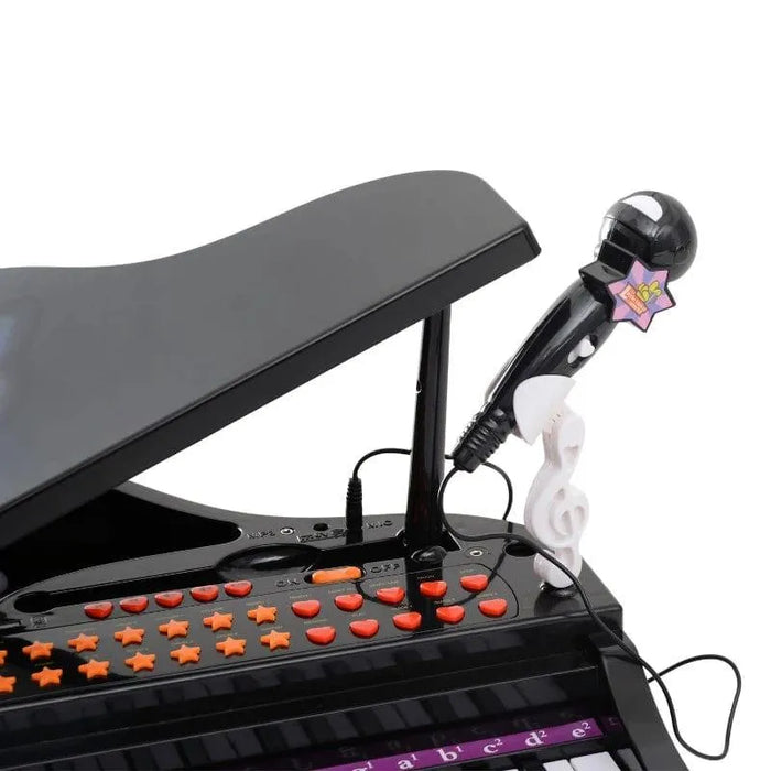 Kids black mini grand piano keyboard with orange buttons and attached toy microphone