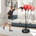 Boy wearing black boxing gloves punching a red freestanding punching bag in a modern living room