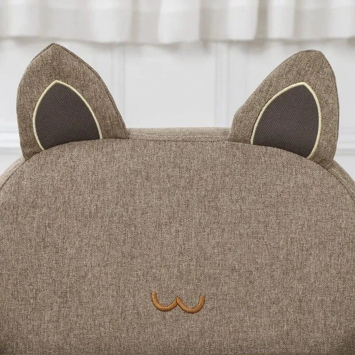 Kids chair in brown fabric with cat ear-shaped backrest and embroidered face detail