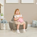 Child sitting on brown kids chair with ear-shaped backrest, holding plush toy in playroom