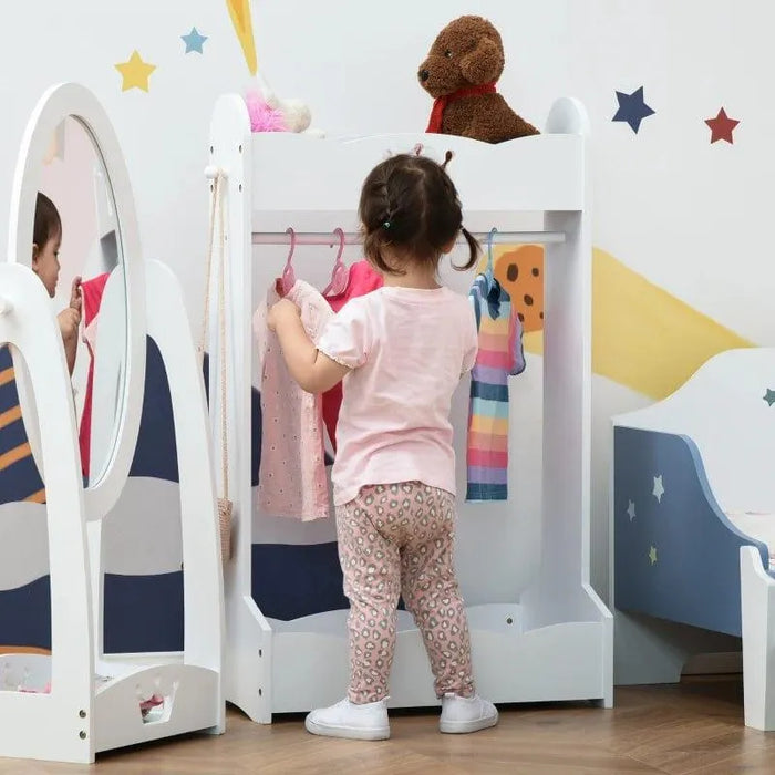 Toddler choosing clothes at a white kids' clothes rack with crown design and storage