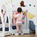 Toddler choosing clothes at a white kids' clothes rack with crown design and storage