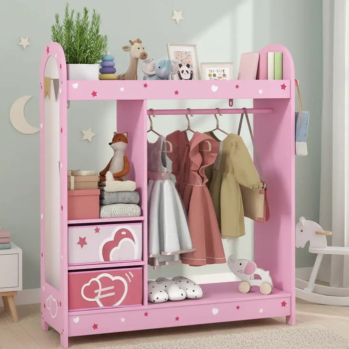 Pink kids clothes rail with cute star and heart prints, hanging dresses, toys, books, and storage boxes