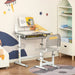 Grey adjustable kids desk and chair set with USB lamp in a colorful children's room