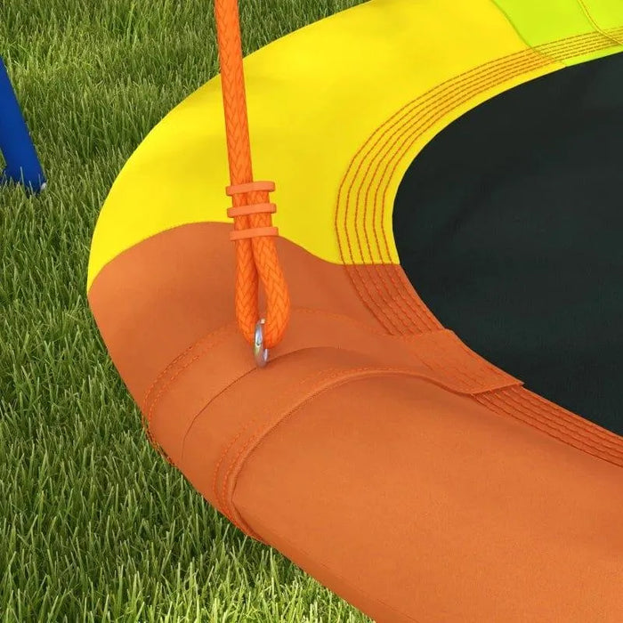 Close-up of multicoloured kids disc swing seat with orange rope on grass