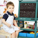 Child sitting by blue double-sided kids easel with chalkboard animal drawings.