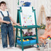 Kids with double-sided easel, paper roll, art supplies, and toys in a playroom setting