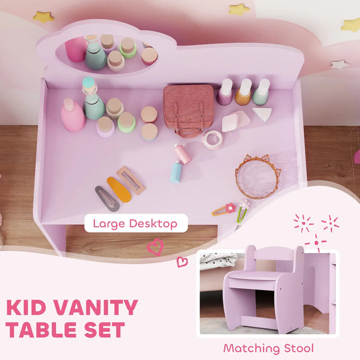 Pink kid vanity table set with various accessories on a wooden surface.