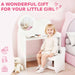 Young girl sitting on a white chair in a pink room with text 'A Wonderful Gift For Your Little Girl'.