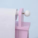 Close-up of pink kids easel paper roll holder with white knob and smooth pastel finish