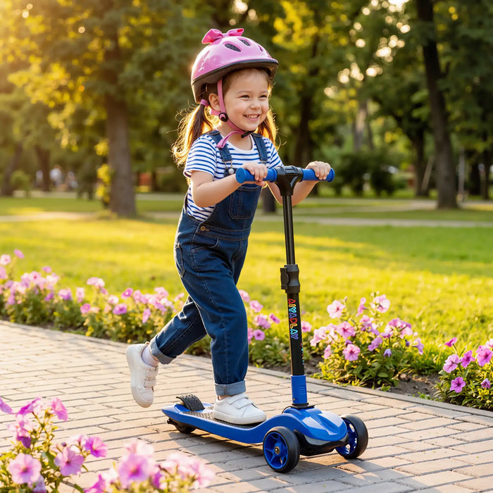 Happy little girl wearing pink helmet riding blue three-wheeled scooter on park path with flowers