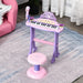 Kids pink and purple electronic keyboard with microphone and stool set on a rug in a playroom.