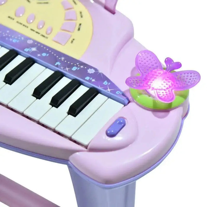Pink kids electronic keyboard with 32 keys, buttons, and a light-up butterfly detail.