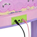 Close-up of pink kids electronic keyboard with input jacks and attached cables