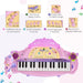 Pink kids electronic keyboard with 32 keys, microphone, and labeled musical features.