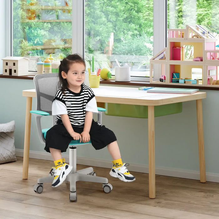 Child sitting on turquoise and gray swivel computer desk chair in a bright playroom with wooden desk and toys