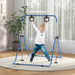 Child playing on blue adjustable indoor gymnastics bar with bear-shaped rings in bright room