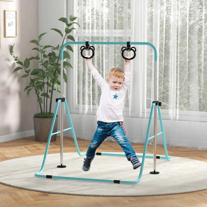 Young boy playing on a blue adjustable steel gymnastics bar with black rings indoors on a round carpet