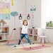 Child playing on pink adjustable steel gymnastics bar with rings in a bright kids' playroom