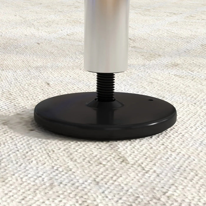 Close-up of adjustable steel gymnastics bar base on woven carpet at Little and Giant Explorers toy store