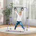 Young boy hanging on adjustable purple steel gymnastics bar with bear-shaped rings indoors on rug