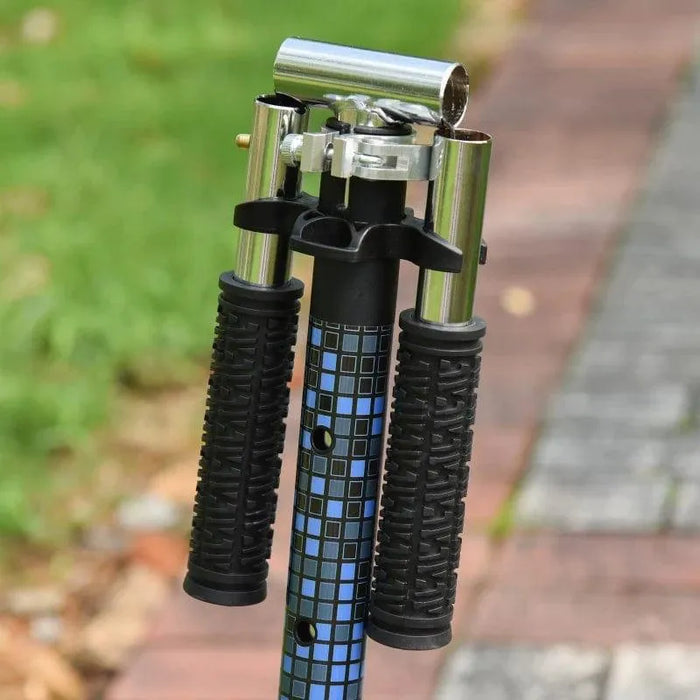 Folded kids kick scooter handlebar with adjustable height, black grips, outdoor setting