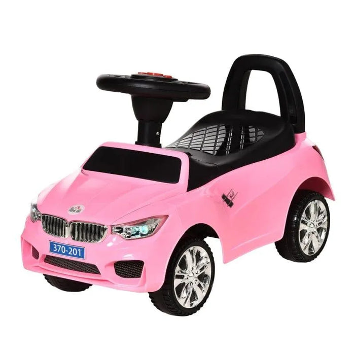 Pink toddler foot-to-floor ride-on car with steering wheel, music, and lights