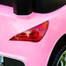 Close-up of pink kids ride-on car rear light and wheel
