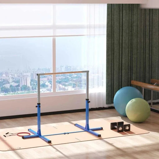 Kids blue steel adjustable gymnastics horizontal bar in bright indoor gym with exercise balls