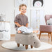Smiling child sitting on kids hippo storage stool in playful, modern nursery room